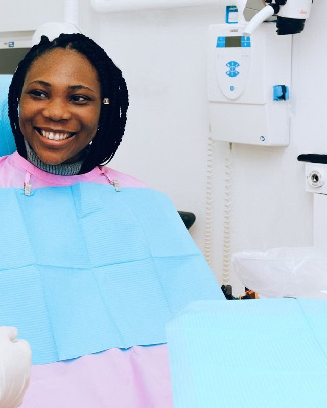 A smiling patient in the dental chair with her dentist