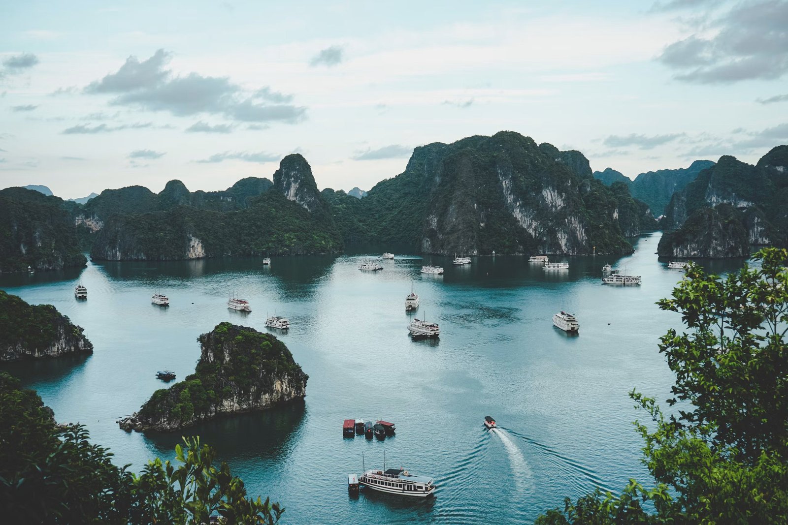 Limestone islands and boats across Ha Long Bay